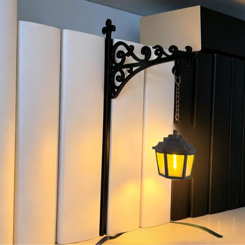 Hexagon lantern bookshelf night light glowing between books